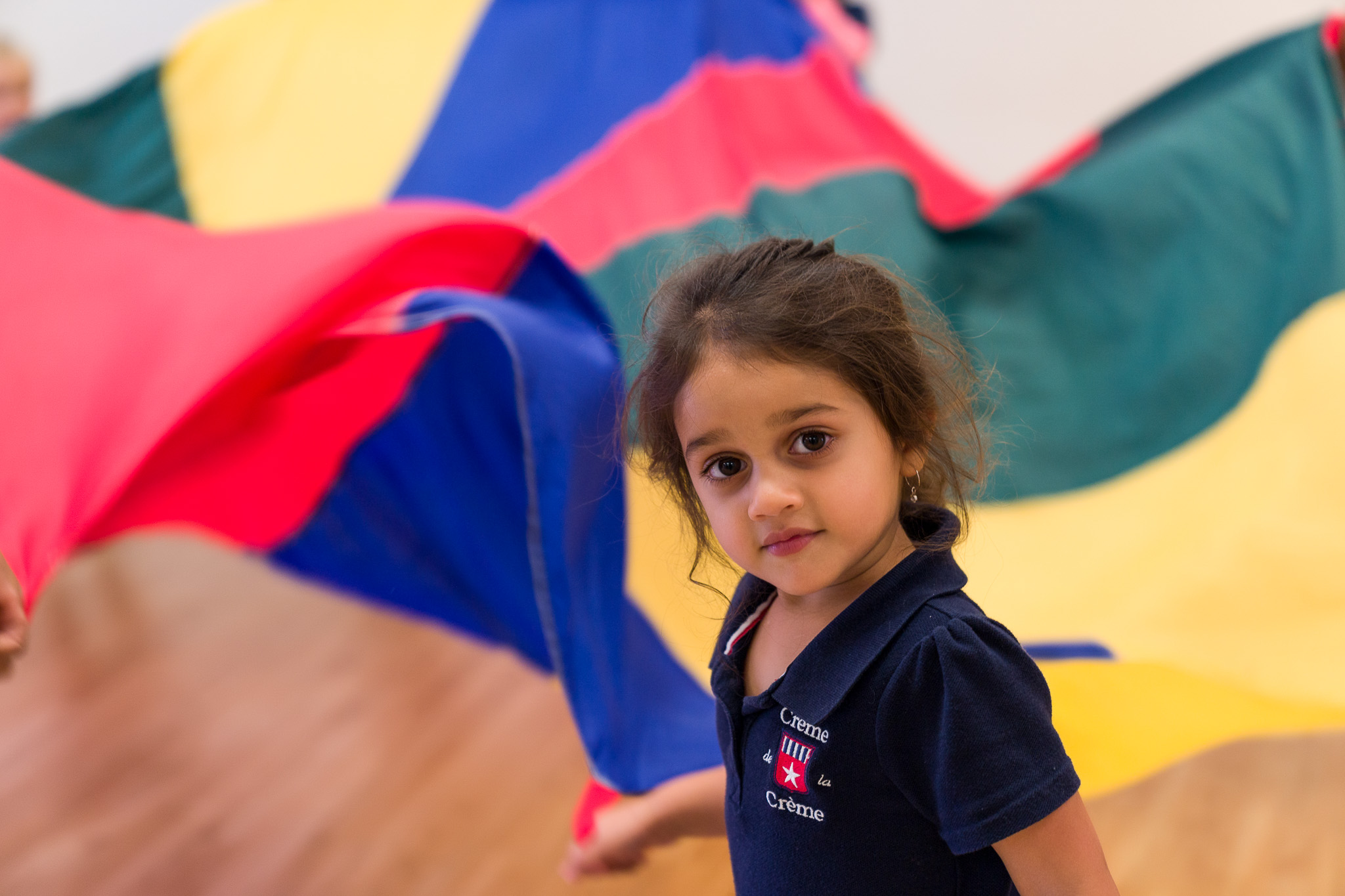 Student playing with a parachute