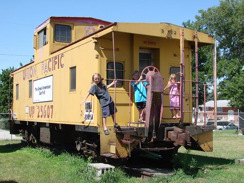 Children posing on a caboose train car.
