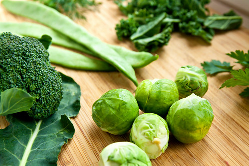 A table full of fresh green organic vegetables.