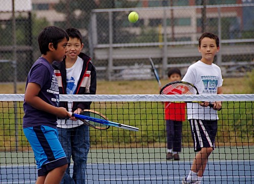 Kids playing tennis.