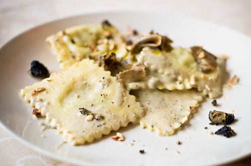 A modern plate of ravioli with a simple butter and cracked black pepper sauce.