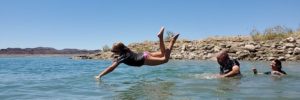 A young girl diving into the water at Lake Mead.