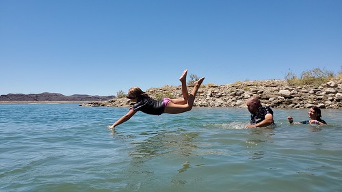 A young girl diving into the water at Lake Mead.