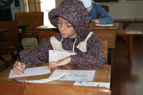 A child actor playing the part of a student at the Historic Oxford Schoolhouse.