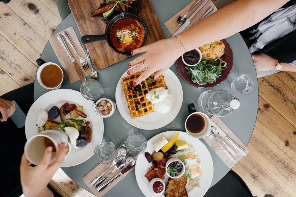 A top-down picture of a cafe table with a massive brunch spread.