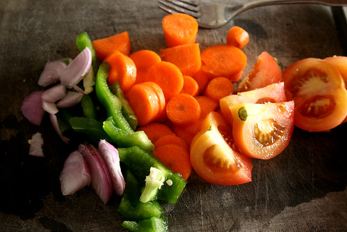 A board full of fresh and vibrant summertime vegetables.