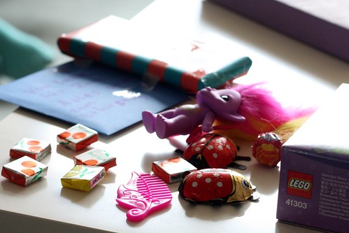 A pile of small toys and presents being prepared to be given as Christmas gifts.