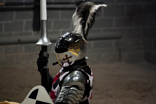 A knight in gleaming armor readying himself to joust.