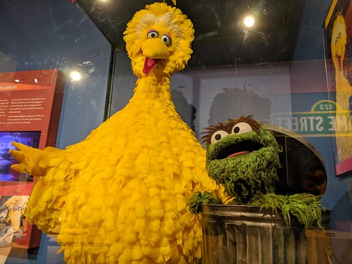 A museum display that feature Big Bird and Oscar the Grouch from Sesame Street.