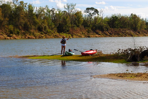 A couple, with their kayaks enjoying some down time while making their way down the Trinity River.