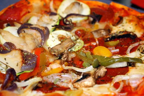 Perfectly cooked pizza with fresh mushrooms, peppers, onions, and more.