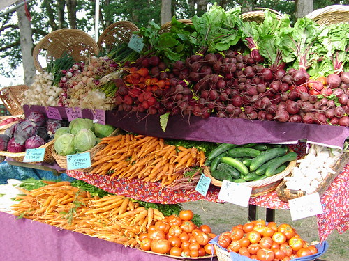 Fresh vegetables layed out at a local farmers market table.