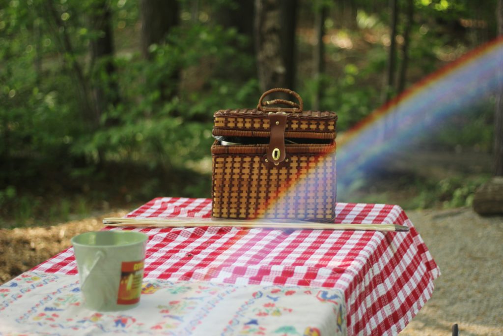 A picnic basket on a table in a local park.