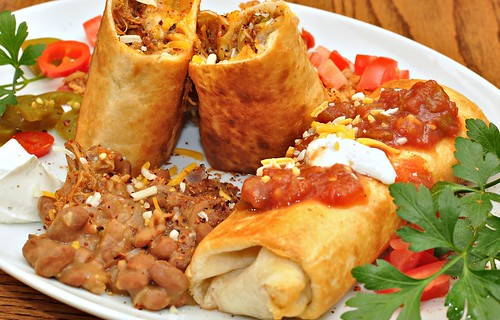 A hot and crispy chimichanga with rice and beans.
