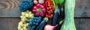 A colorful selection of fresh produce on a rustic wooden table.