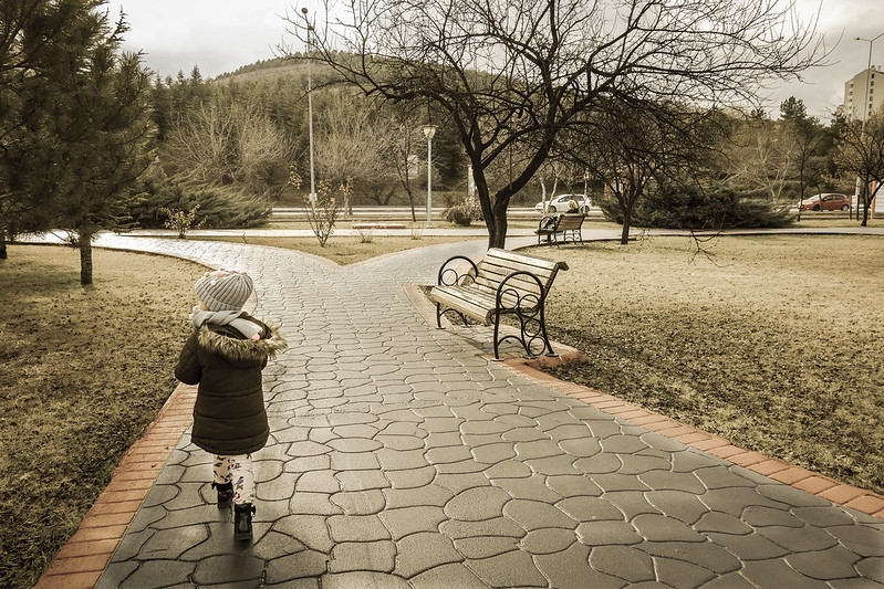 A young girl making her way down a walking path in Leawood Park in Leawood, Kansas.