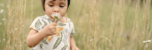 A young girl makes a wish on a dandelion at a wildlife sanctuary in McKinney, TX