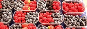 Blueberries, blackberries and raspberries in baskets