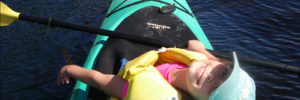 A young girl sits in a kayak on Tempe Town Lake near Mesa, Arizona