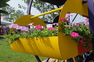 A yellow basket holding pink and purple flowers at the Leesburg Flower & Garden festival in Ashburn, Virginia
