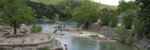 People swimming in the river at Turner Falls Park near Colleyville, TX