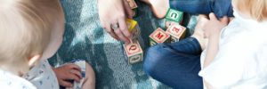 Two young children playing with letter blocks during a language class near Glenview, IL