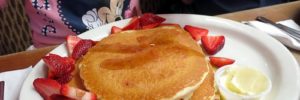 A pile of pancakes on a plate at a family-friendly restaurant in Plano, TX