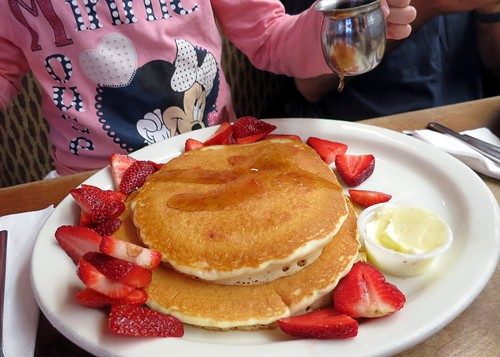 A pile of pancakes on a plate at a family-friendly restaurant in Plano, TX