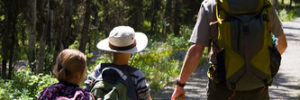 A father and his kids walk through the Webb Bridge Park & Arborteum in Alpharetta, GA