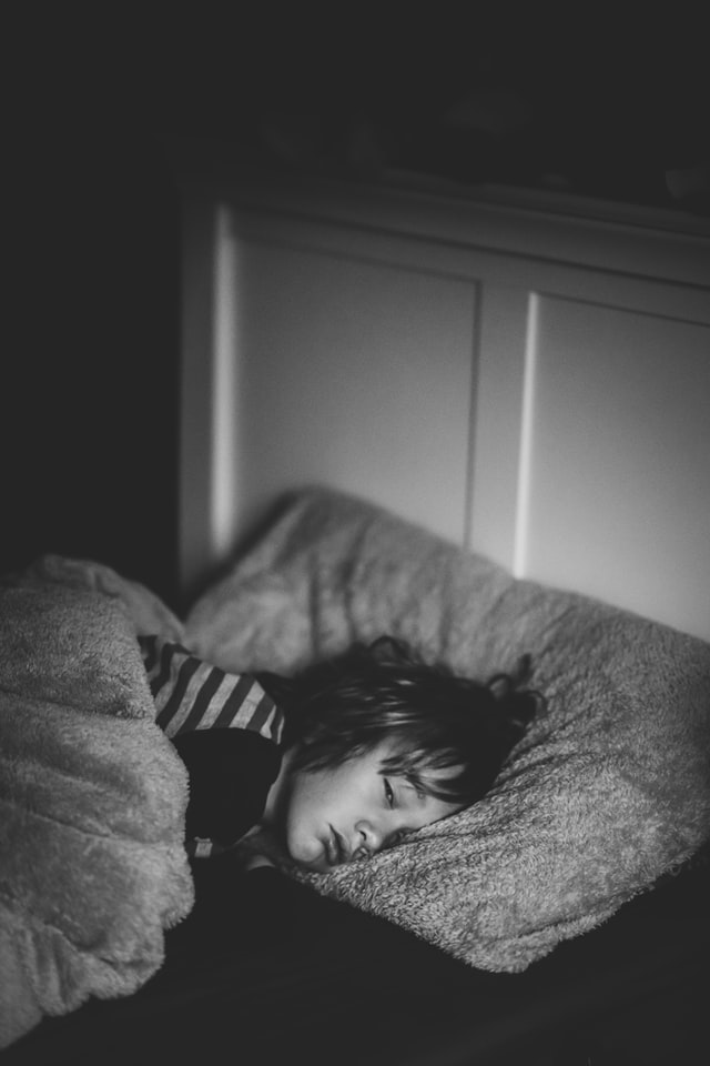 A young boy sleeps during daylight savings time