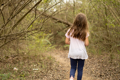 A girl takes a hike through the woods in Alpharetta, GA