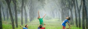 Four kids play with a ball in a field in Frisco, TX