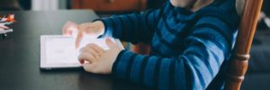A child using a tablet at the table