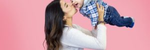 A mother holds her son in the air playfully during a mommy and me class in Mount Laurel, New Jersey