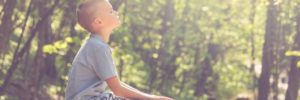 A boy meditates at a park in South Barrington, Illinois