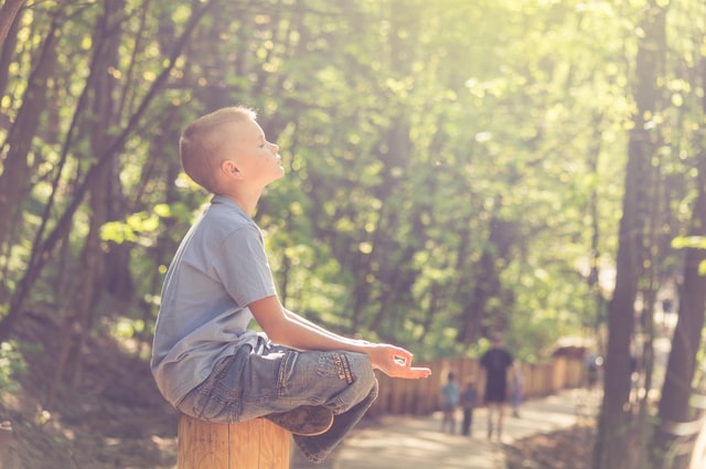 A boy meditates at a park in South Barrington, Illinois