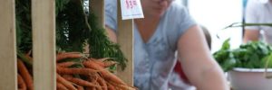 A woman prepares her vegetables for a farmers market in Las Vegas, NV