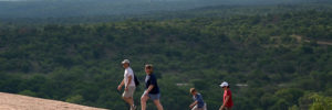 A family of four walks up a steep hill while hiking in McKinney, Texas