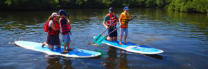 A family kayaks on the river during a day trip from Peachtree Corners, Georgia
