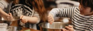 A young boy stirs a mixing bowl during a kids' cooking class in Allen, Texas
