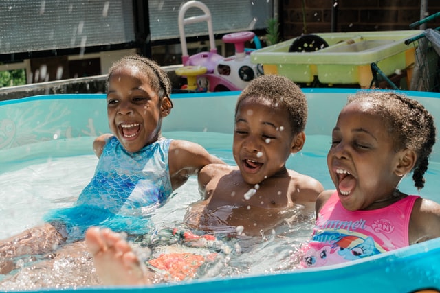 Three kids swimming in a pool at their home in Alpharetta, Georgia