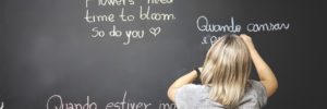 A child writes on the chalkboard during a language class in Mason, Ohio
