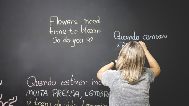 A child writes on the chalkboard during a language class in Mason, Ohio
