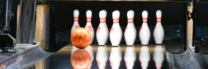 A bowling ball rolls toward pins at a bowling alley party venue in Coppell, Texas