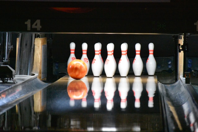A bowling ball rolls toward pins at a bowling alley party venue in Coppell, Texas