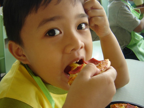A child takes a bite of pizza at a family-friendly restaurant in Mount Laurel, New Jersey