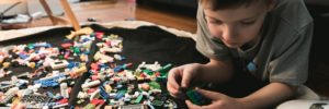 A boy plays with legos while developing his STEM skills