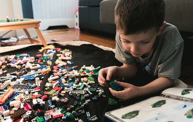 A boy plays with legos while developing his STEM skills