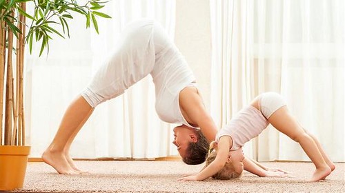 Parent and child doing yoga exercise