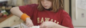 A young girl mixes a bowl of ingredients at a cooking class in South Barrington, Illinois